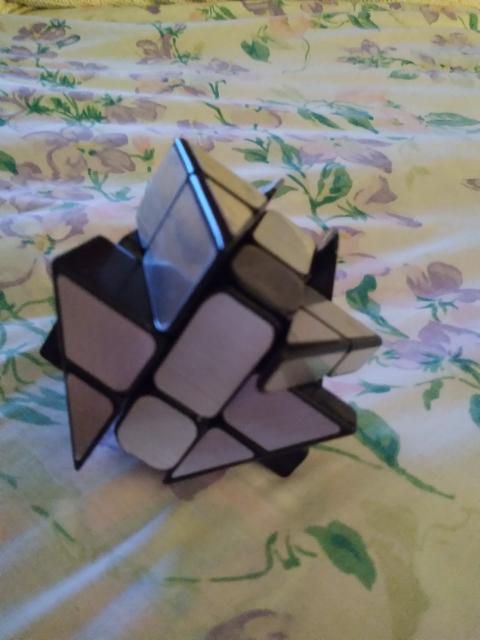 cube with 4 triangular hills around the top, a solid middle, and four feet below